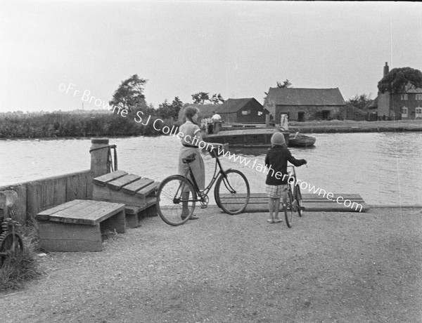 CYCLISTS AWAIT FERRY